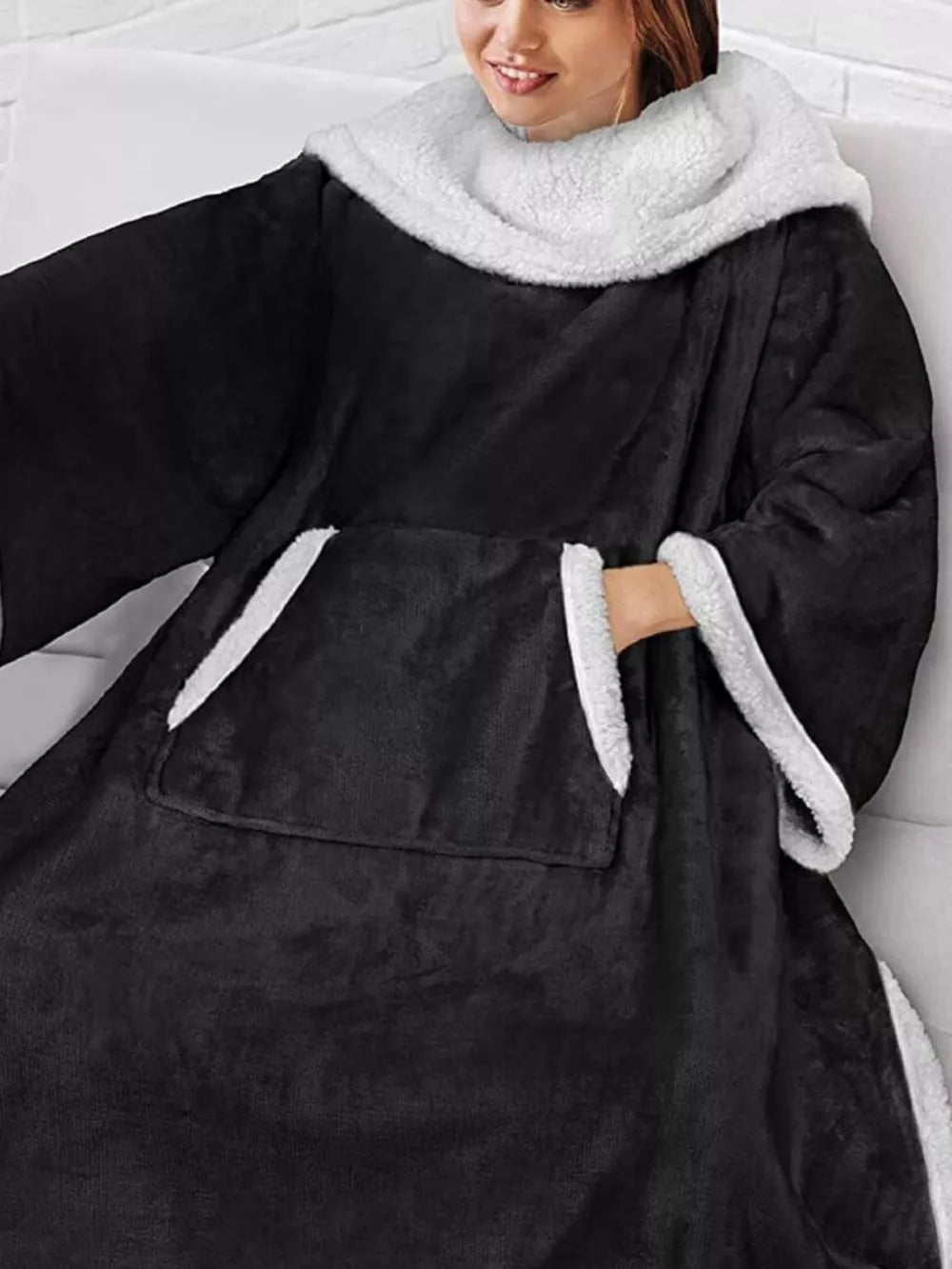 Black sherpa-trim wearable blanket — pocket and sleeve detail